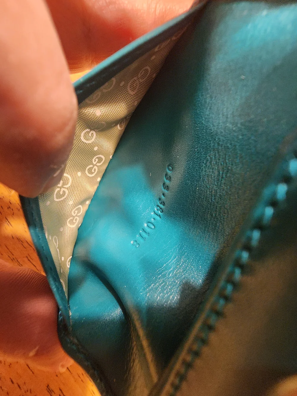 vintage Gucci teal leather key case featuring a distinctive cabochon stone